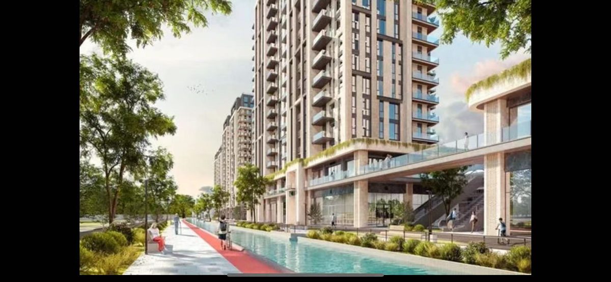 Pedestrian street with swimming pool and landscaped greenery