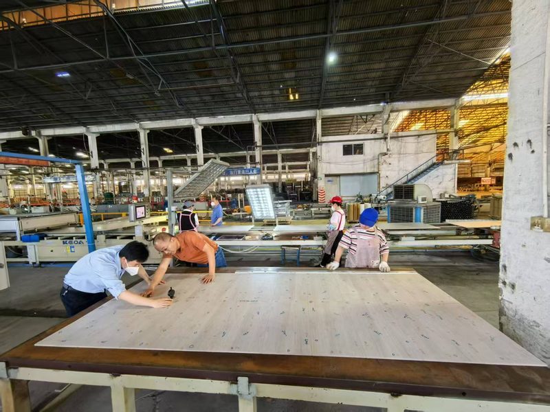 Factory QC team inspecting large-format porcelain tiles before shipment